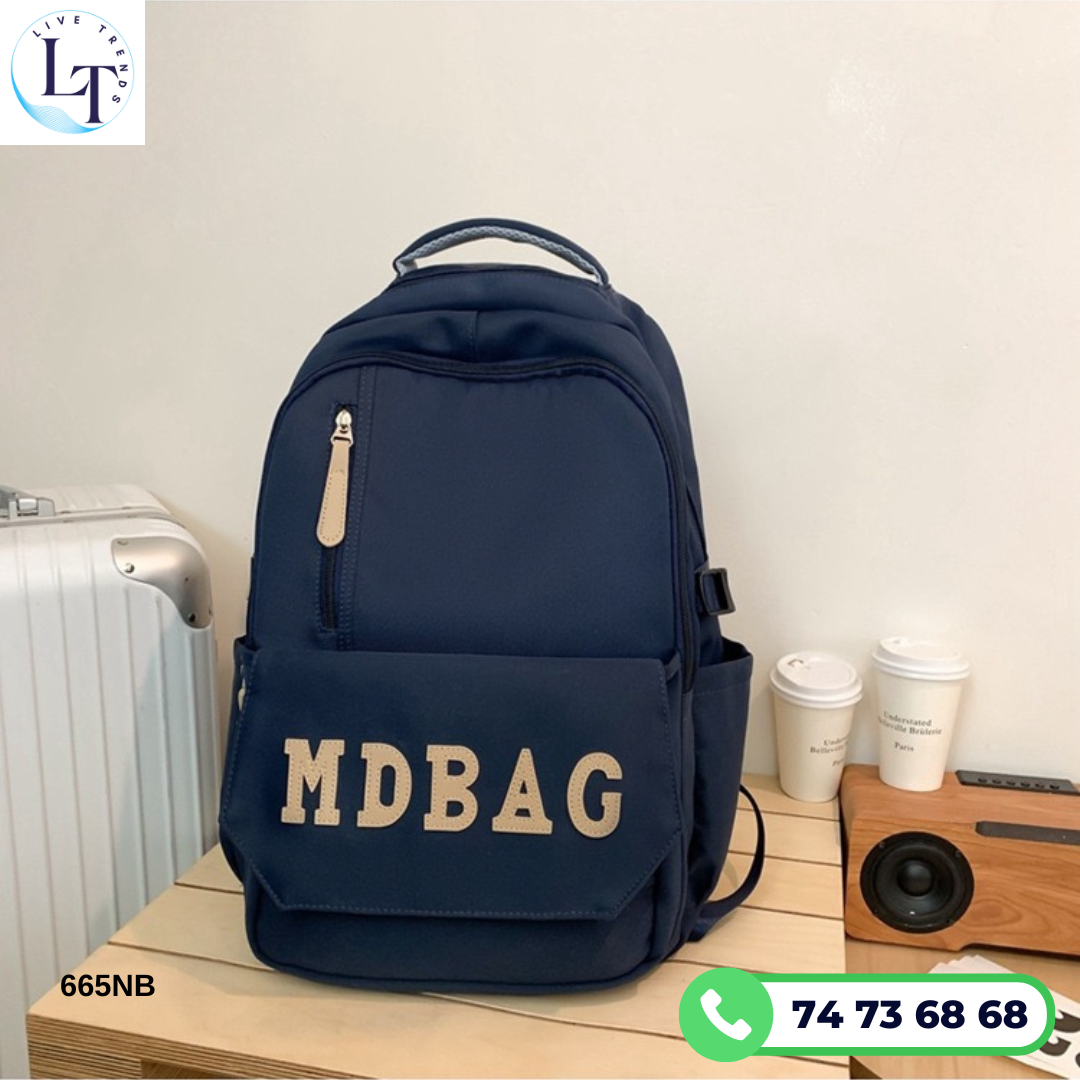 Navy blue backpack with 'MDBAG' text on a wooden surface with a light background